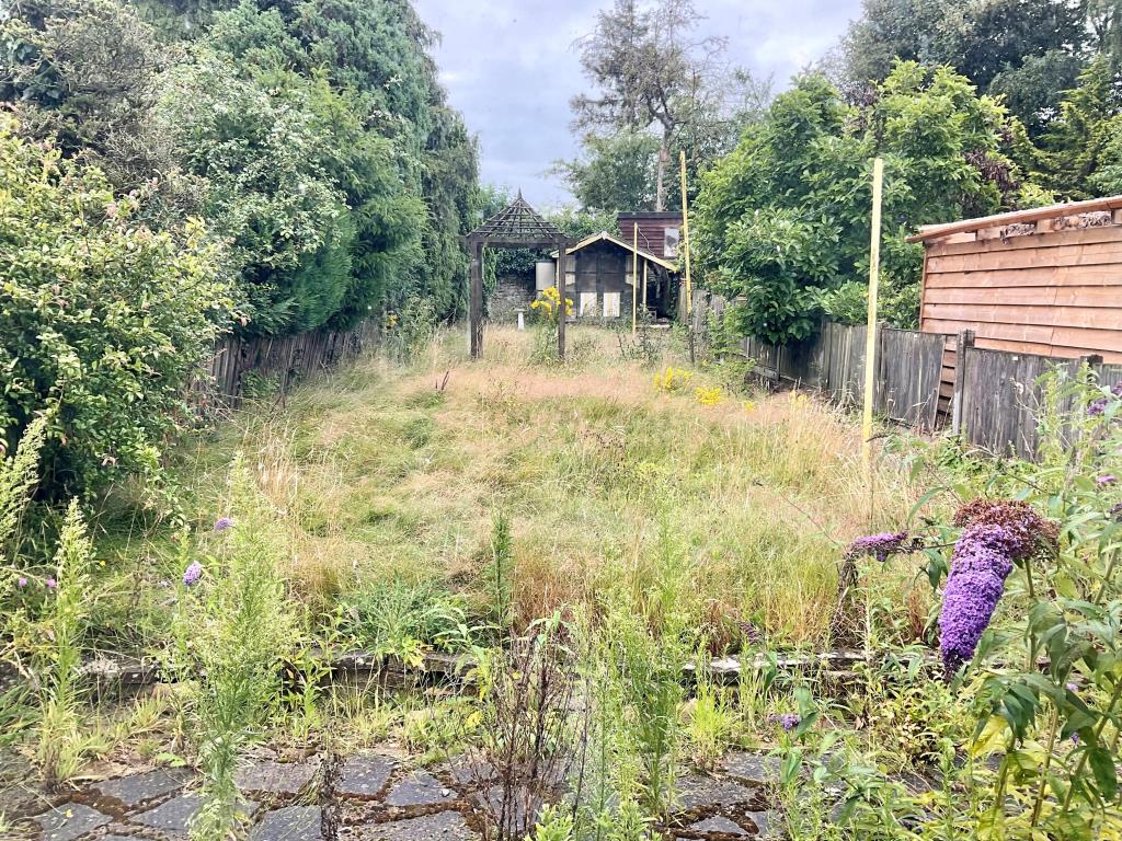 Lot: 63 - TWO-BEDROOM HOUSE FOR REFURBISHMENT - Garden with patio area and shed